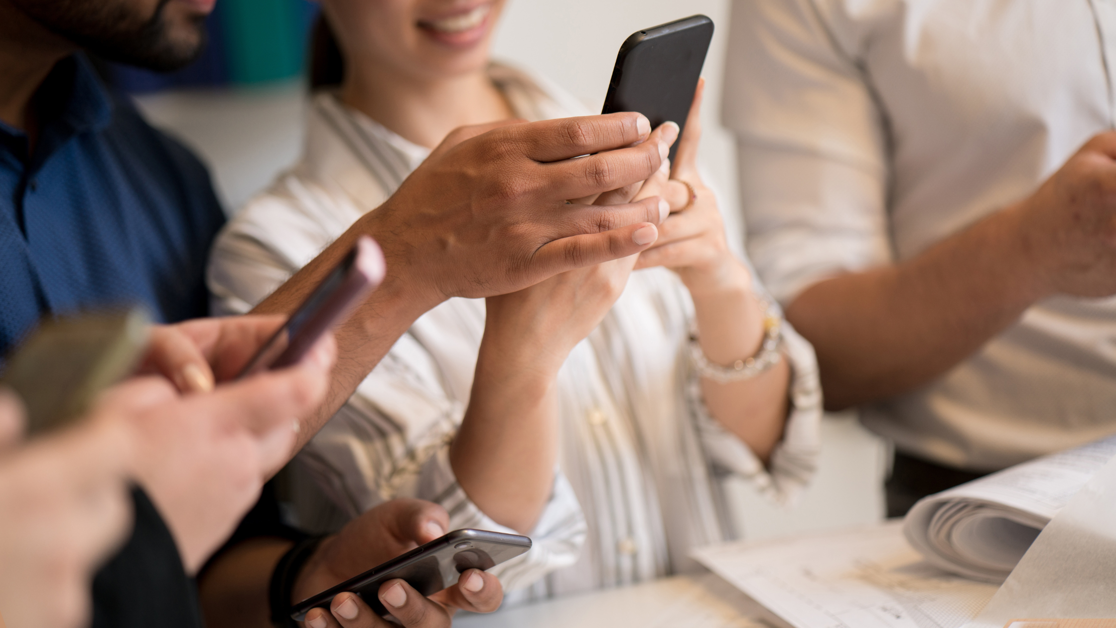 Person looking at their phone, analyzing social media engagement and metrics.